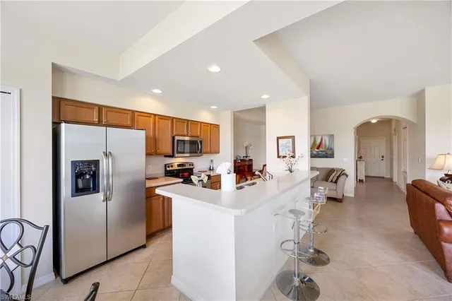 a kitchen with refrigerator a sink and cabinets