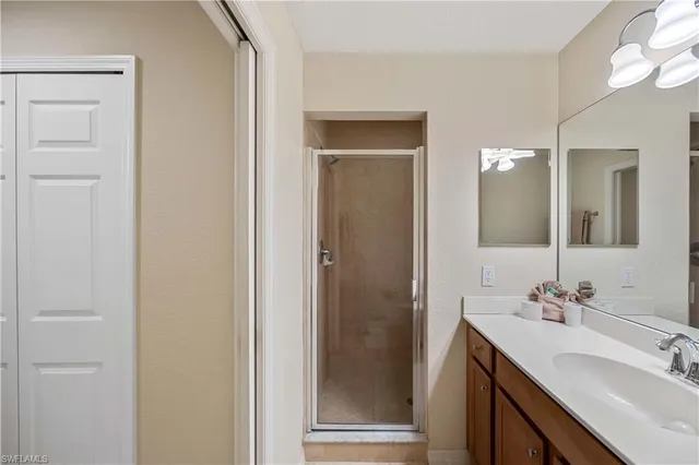 a bathroom with a double vanity sink mirror and shower