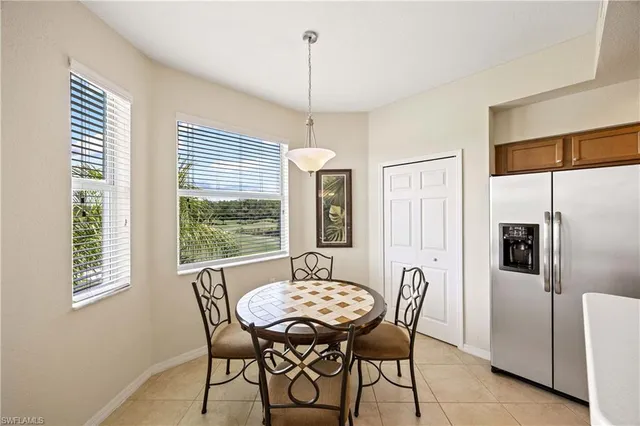 a dining room with furniture a chandelier and window