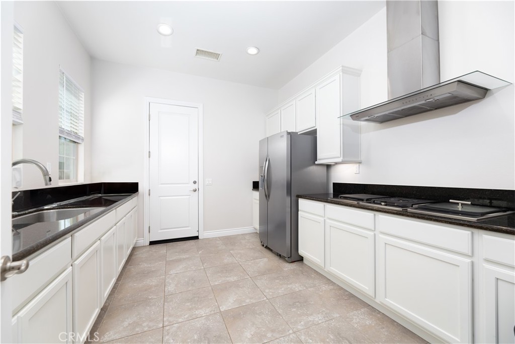 60 Gainsboro Irvine, CA 92620 - Photo 12 of 34 a kitchen with granite countertop a sink stove and refrigerator