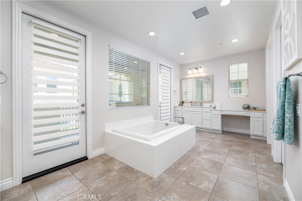60 Gainsboro Irvine, CA 92620 - Photo 14 of 34 a spacious bathroom with a double vanity sink a mirror and a bathtub