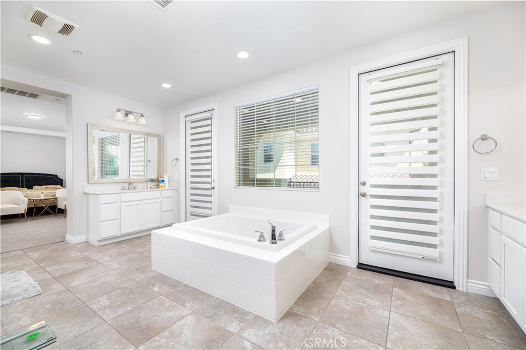 60 Gainsboro Irvine, CA 92620 - Photo 18 of 34 a spacious bedroom with a bed and a couch