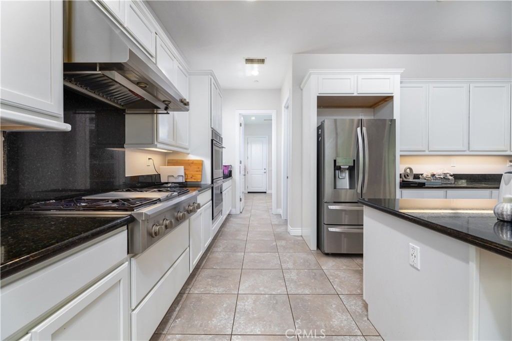 60 Gainsboro Irvine, CA 92620 - Photo 4 of 34 a kitchen with stainless steel appliances granite countertop a stove and a refrigerator