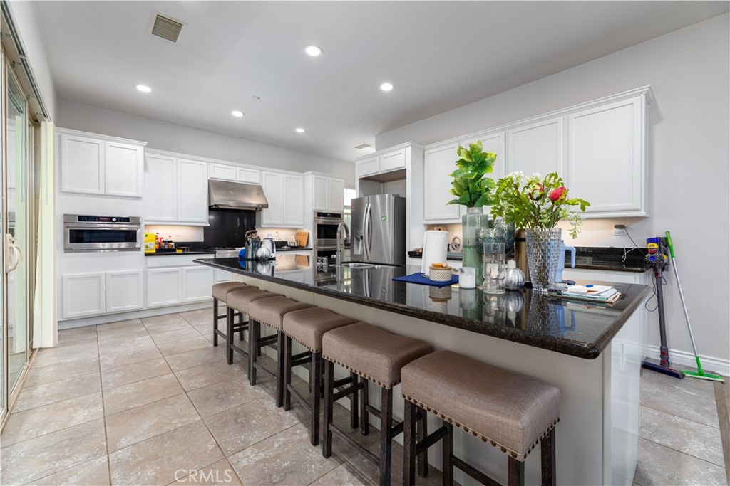 60 Gainsboro Irvine, CA 92620 - Photo 6 of 34 a kitchen with kitchen island granite countertop lots of counter top space and appliances
