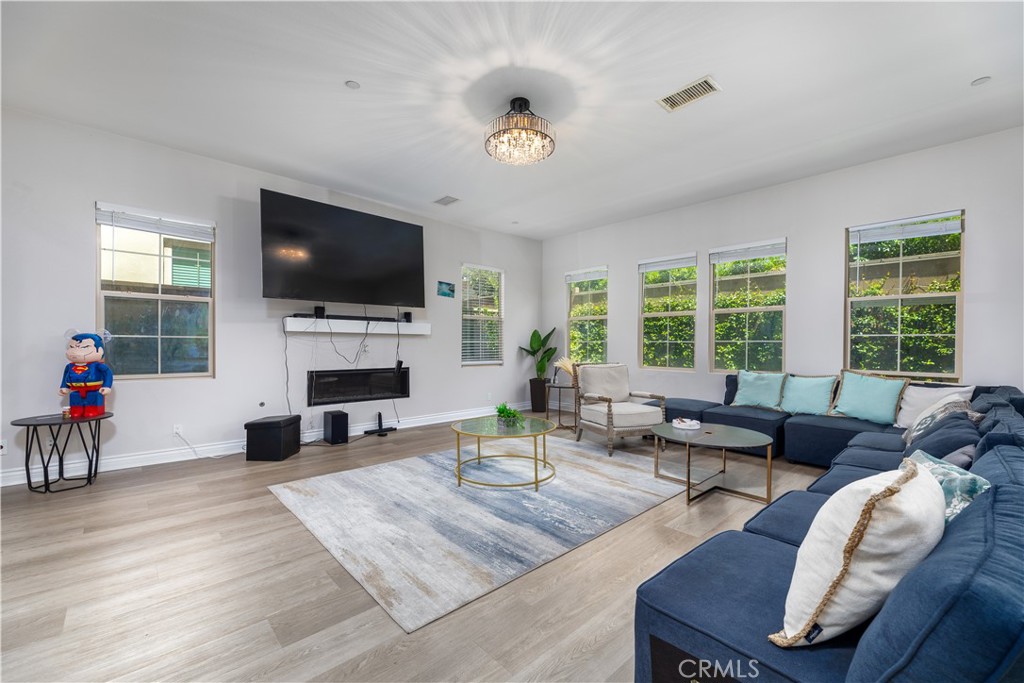 60 Gainsboro Irvine, CA 92620 - Photo 8 of 34 a living room with furniture a fireplace and a flat screen tv