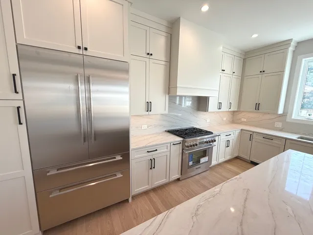 a kitchen with granite countertop stainless steel appliances and wooden cabinets