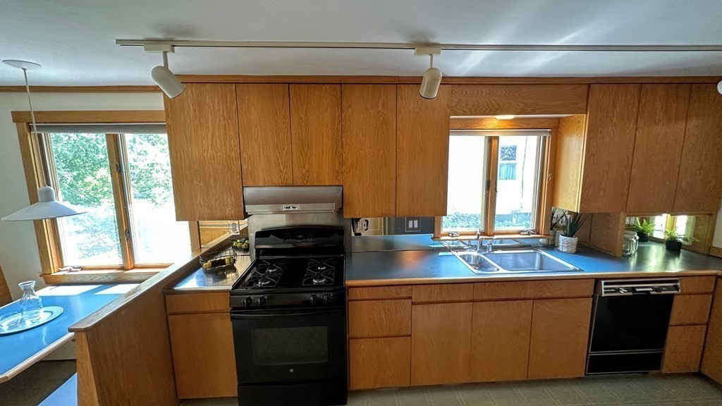 71 Reed Street Lexington, MA 02421 - Photo 4 of 6 a kitchen with stainless steel appliances wooden cabinets and a stove top oven