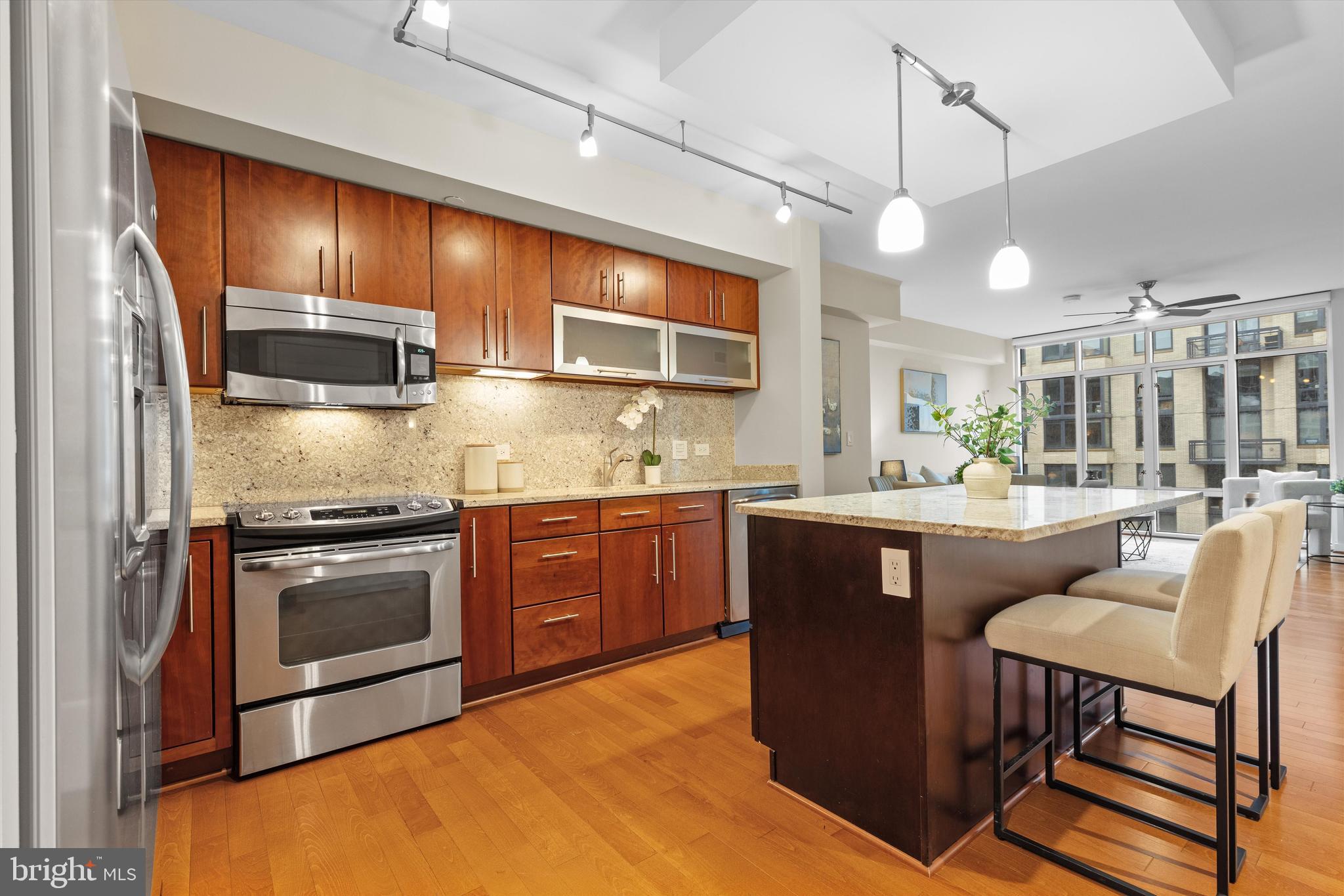 1025 First Street Southeast, Unit 1114 Washington, DC 20003 - Photo 1 of 23 a kitchen with stainless steel appliances granite countertop a stove a sink and a refrigerator
