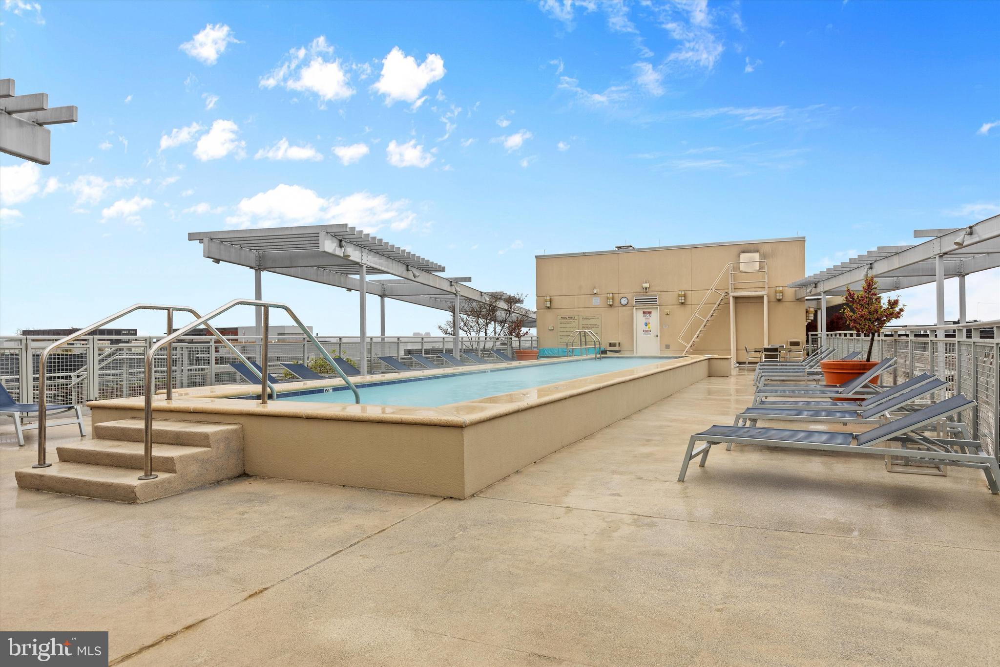 1025 First Street Southeast, Unit 1114 Washington, DC 20003 - Photo 20 of 23 a view of a swimming pool with a lounge chair