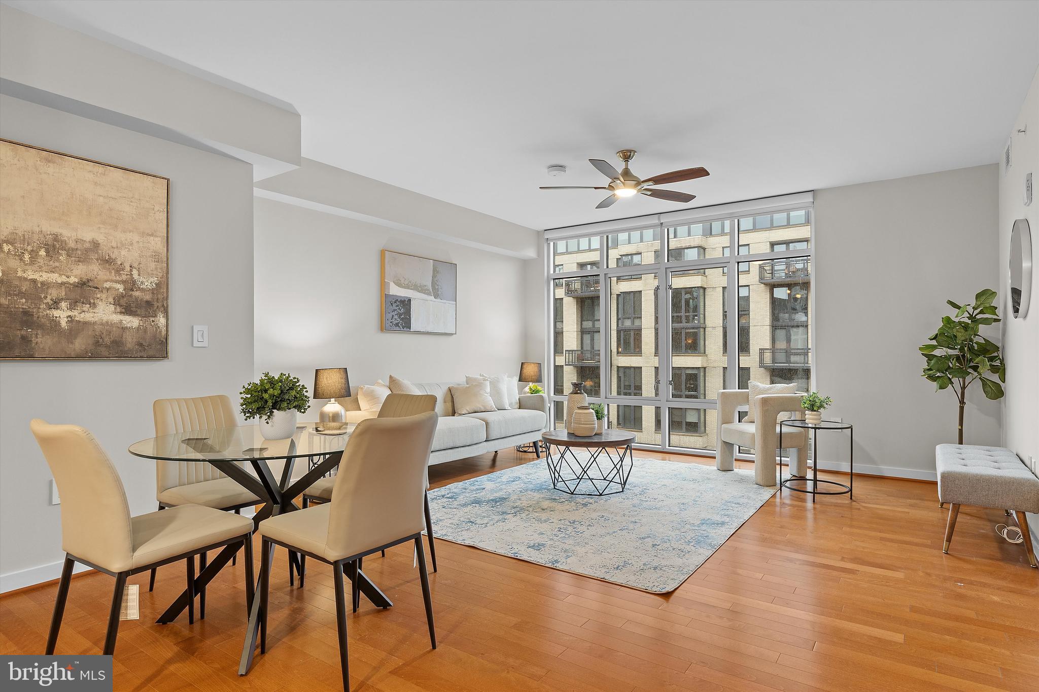 1025 First Street Southeast, Unit 1114 Washington, DC 20003 - Photo 6 of 23 a dining room with furniture a rug a potted plant and a painting