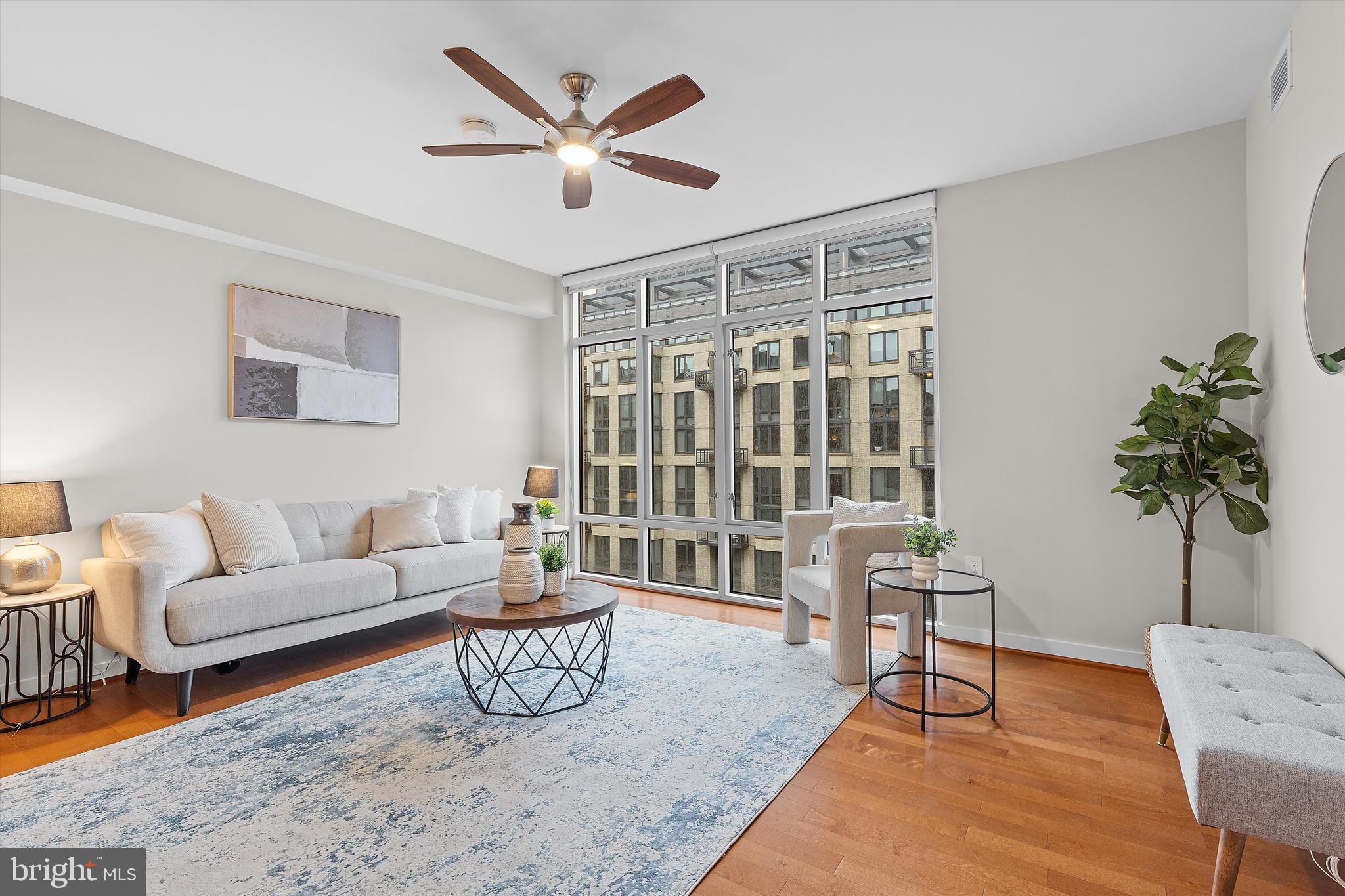 1025 First Street Southeast, Unit 1114 Washington, DC 20003 - Photo 7 of 23 a living room with furniture and a potted plant