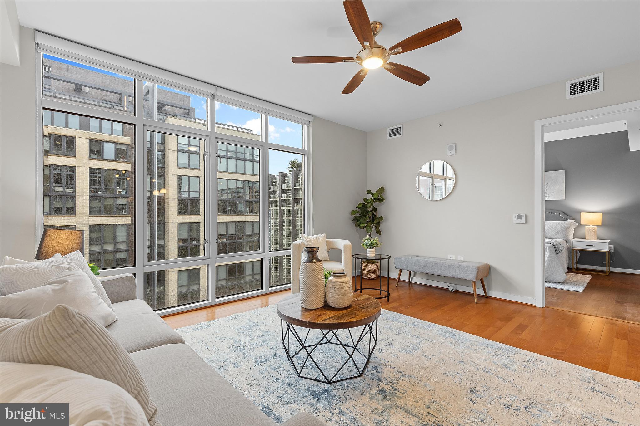 1025 First Street Southeast, Unit 1114 Washington, DC 20003 - Photo 10 of 23 a living room with furniture a table and a large window