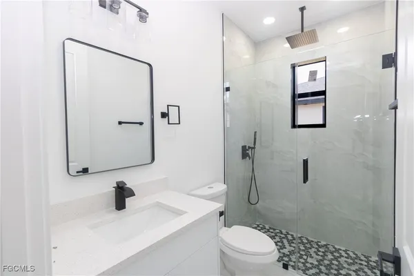 a bathroom with a sink toilet and shower