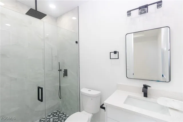 a bathroom with a toilet sink and shower