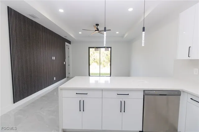 a kitchen with kitchen island and white cabinets