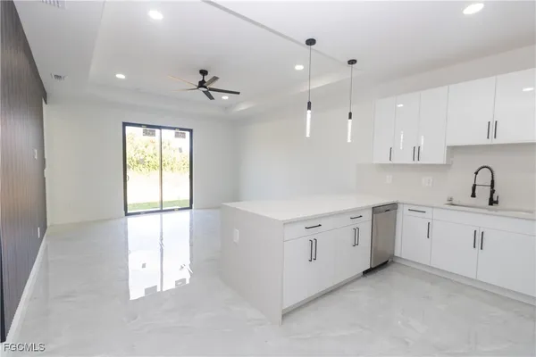 a kitchen with white cabinets and white appliances