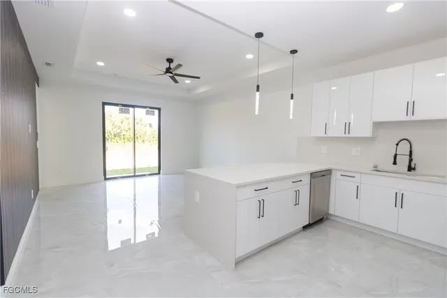 a kitchen with white cabinets and white appliances
