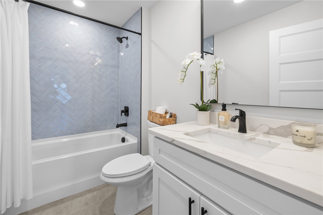 502 Point Road Westminster, SC 29693 - Photo 24 of 45 This modern bathroom features a stylish vanity and a sleek shower with herringbone tile.