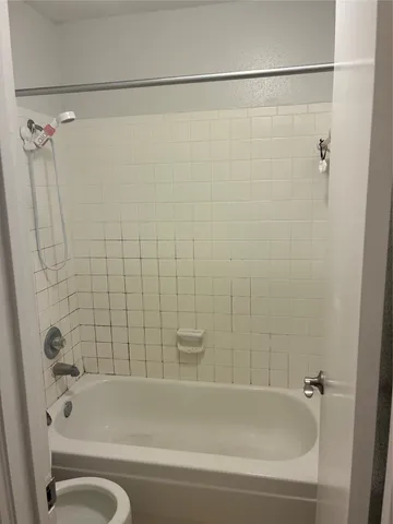 a bathroom with a shower and a bathtub