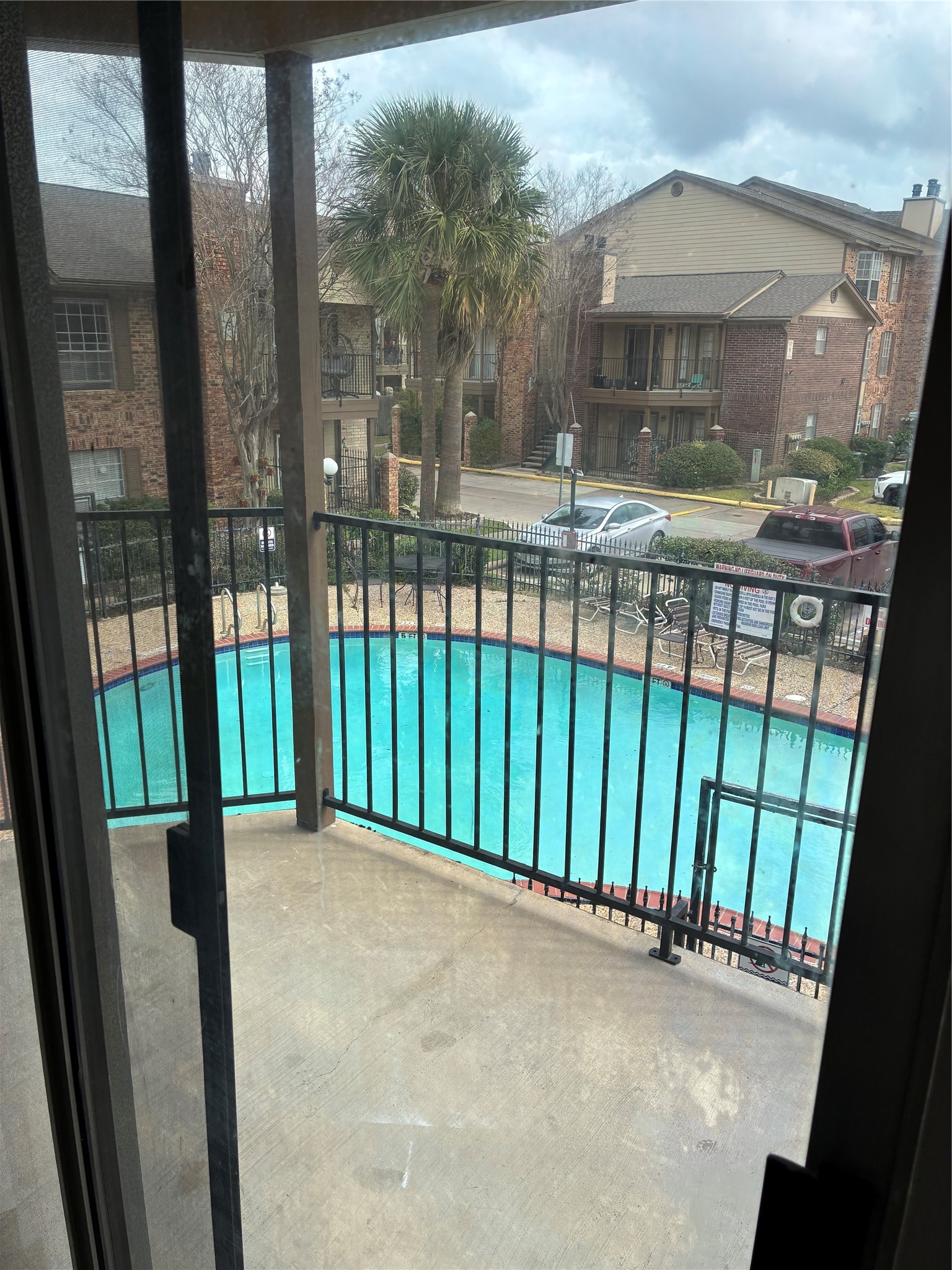 2121 Hepburn Street, Unit 404 Houston, TX 77054 - Photo 27 of 30 a view of a porch with a floor to ceiling window next to a yard