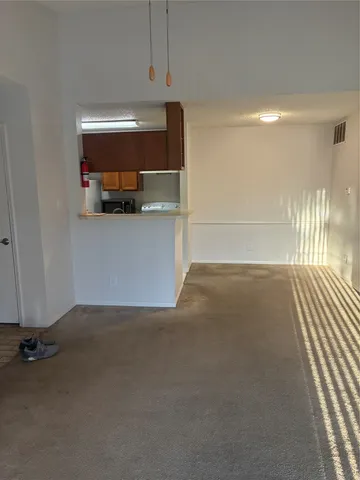 a view of a room with wooden floor