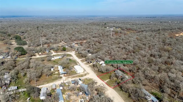 an aerial view of house with yard and mountain view in back