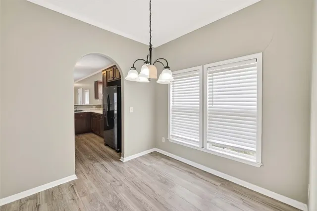 a view of a room with a window and wooden floor