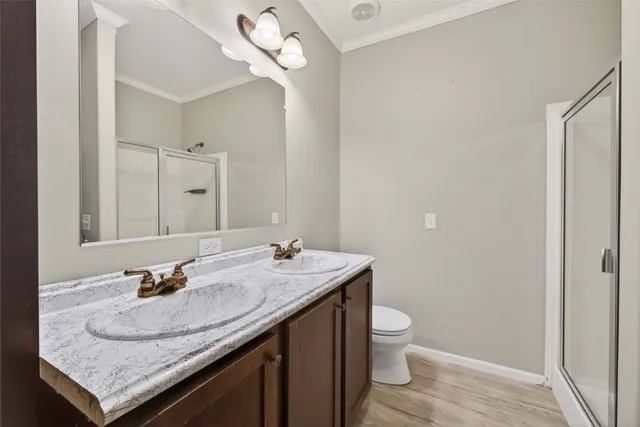 a bathroom with a granite countertop sink a toilet and a mirror