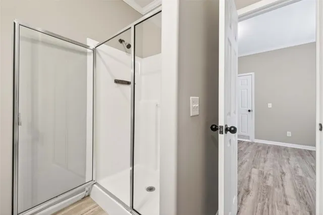 a bathroom with a glass shower door