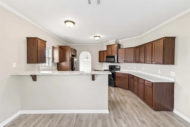 a kitchen with stainless steel appliances granite countertop a stove sink and cabinets
