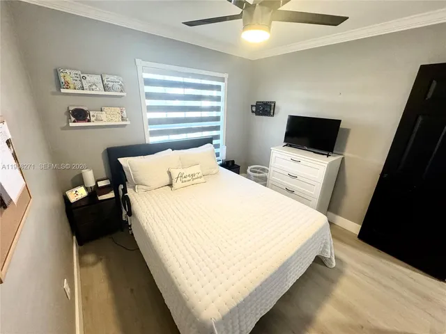 a large bed sitting in a bedroom next to a window