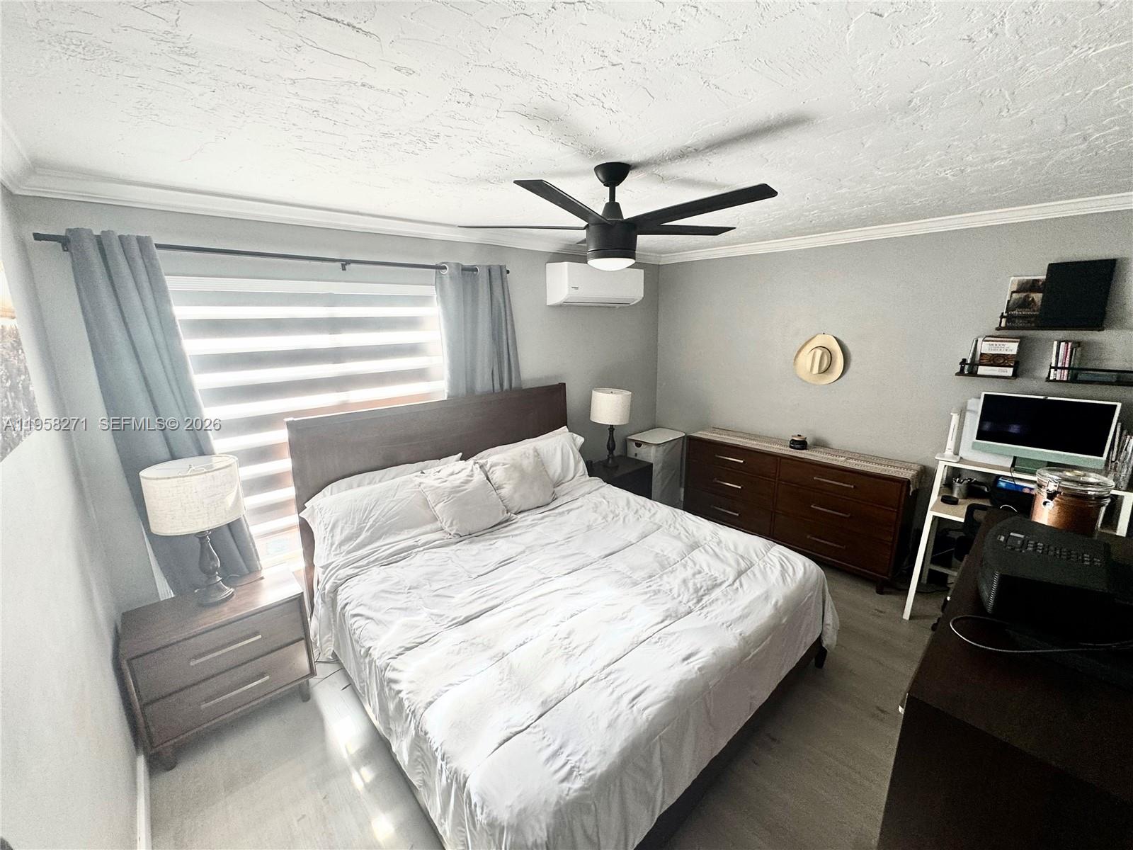 14849 Southwest 114th Court Miami, FL 33176 - Photo 16 of 23 a bedroom with a bed and a flat screen tv