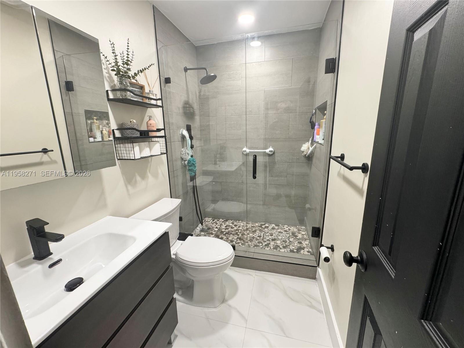 14849 Southwest 114th Court Miami, FL 33176 - Photo 17 of 23 a bathroom with a sink toilet and shower