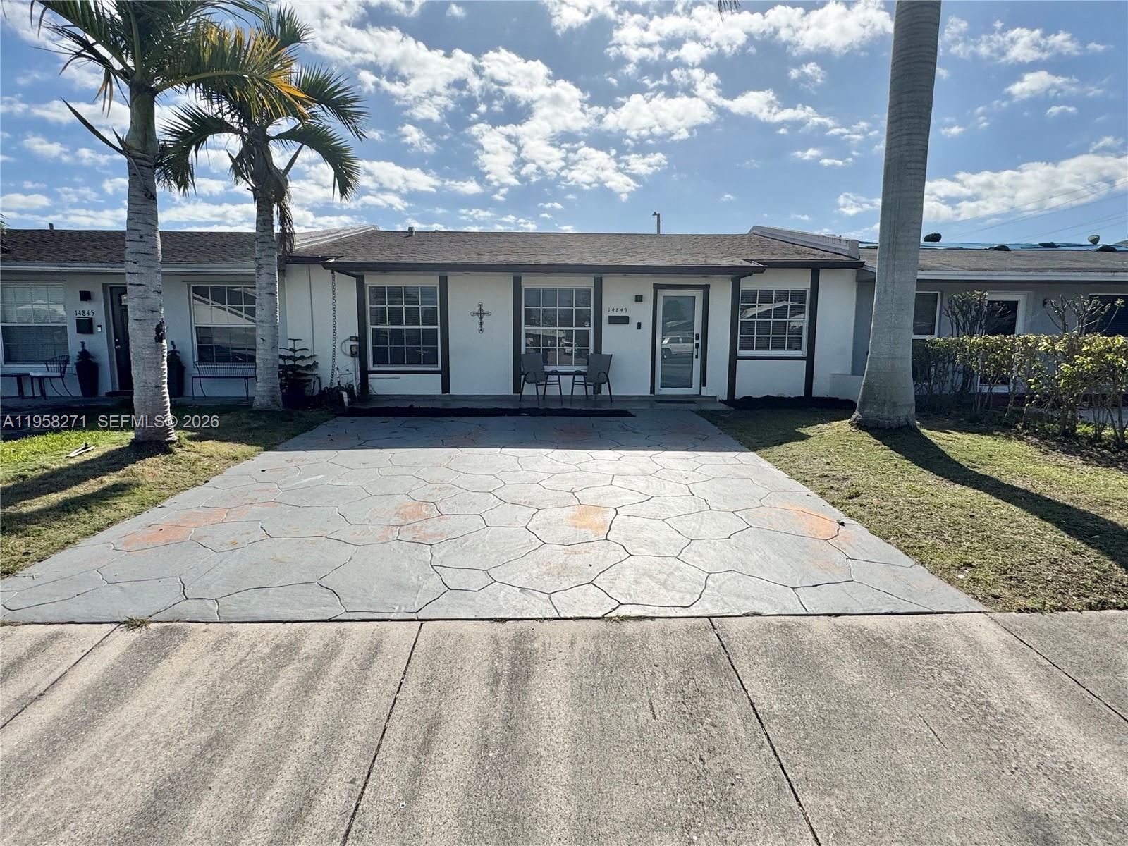 14849 Southwest 114th Court Miami, FL 33176 - Photo 19 of 23 a view of a brick house with many windows