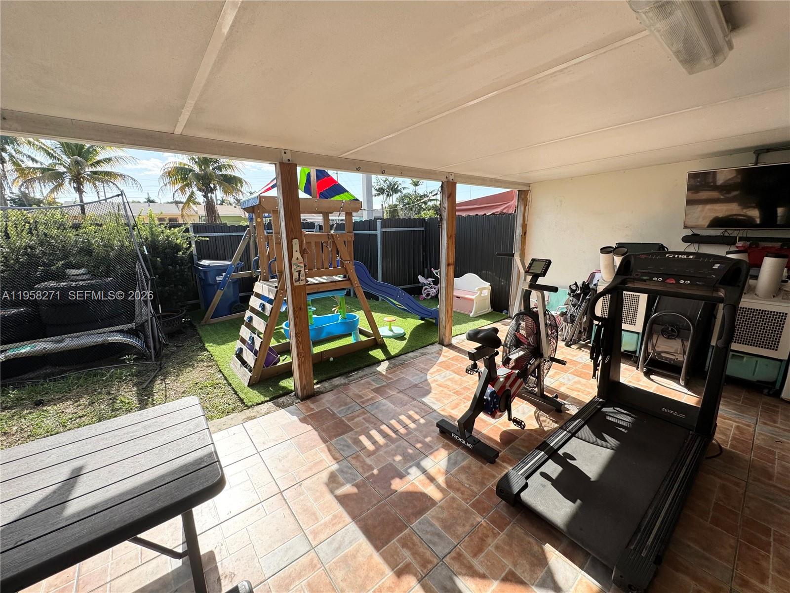 14849 Southwest 114th Court Miami, FL 33176 - Photo 21 of 23 a view of a patio with table and chairs a barbeque