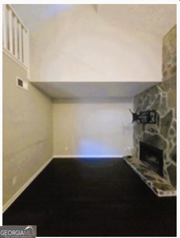 1674 Wynndowne Trail Smyrna, GA 30080 - Photo 5 of 15 a view of empty room with wooden floor and a fireplace