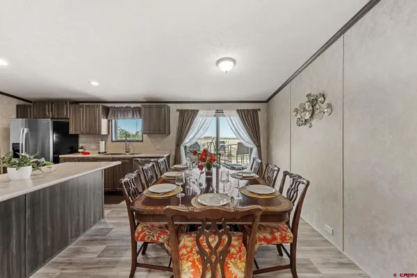 a view of a dining room with furniture and window