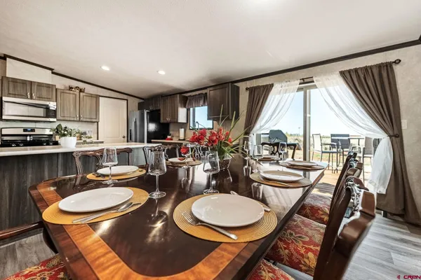 a dining room with furniture a rug and wooden floor