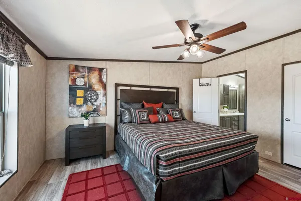 a bedroom with a bed and a chandelier