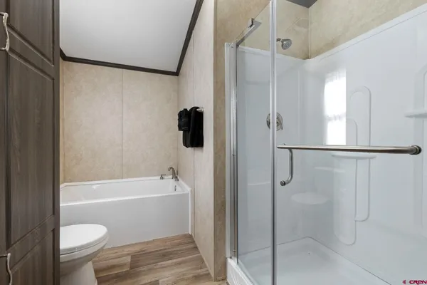 a bathroom with a shower a toilet and a shower