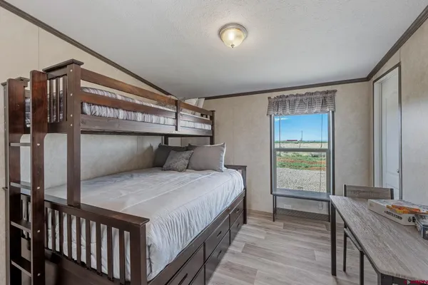 a bedroom with a bed and a table