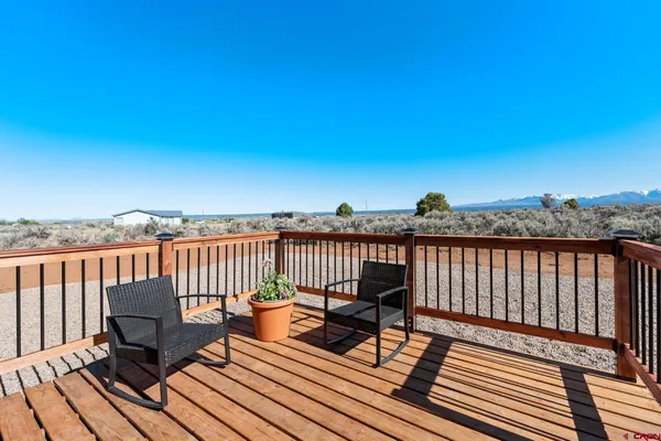 a view of a balcony with wooden floor