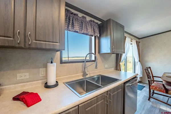 a kitchen with a sink and a wooden floor