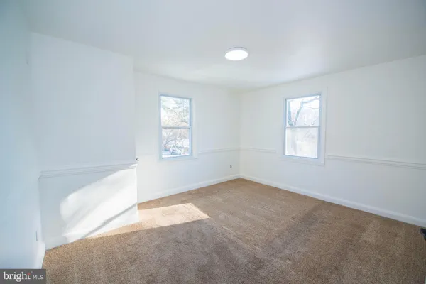a kitchen with a wooden floor and a window
