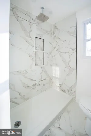 a bathroom with a sink a large mirror and a shower