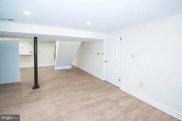 a view of a room with wooden floor
