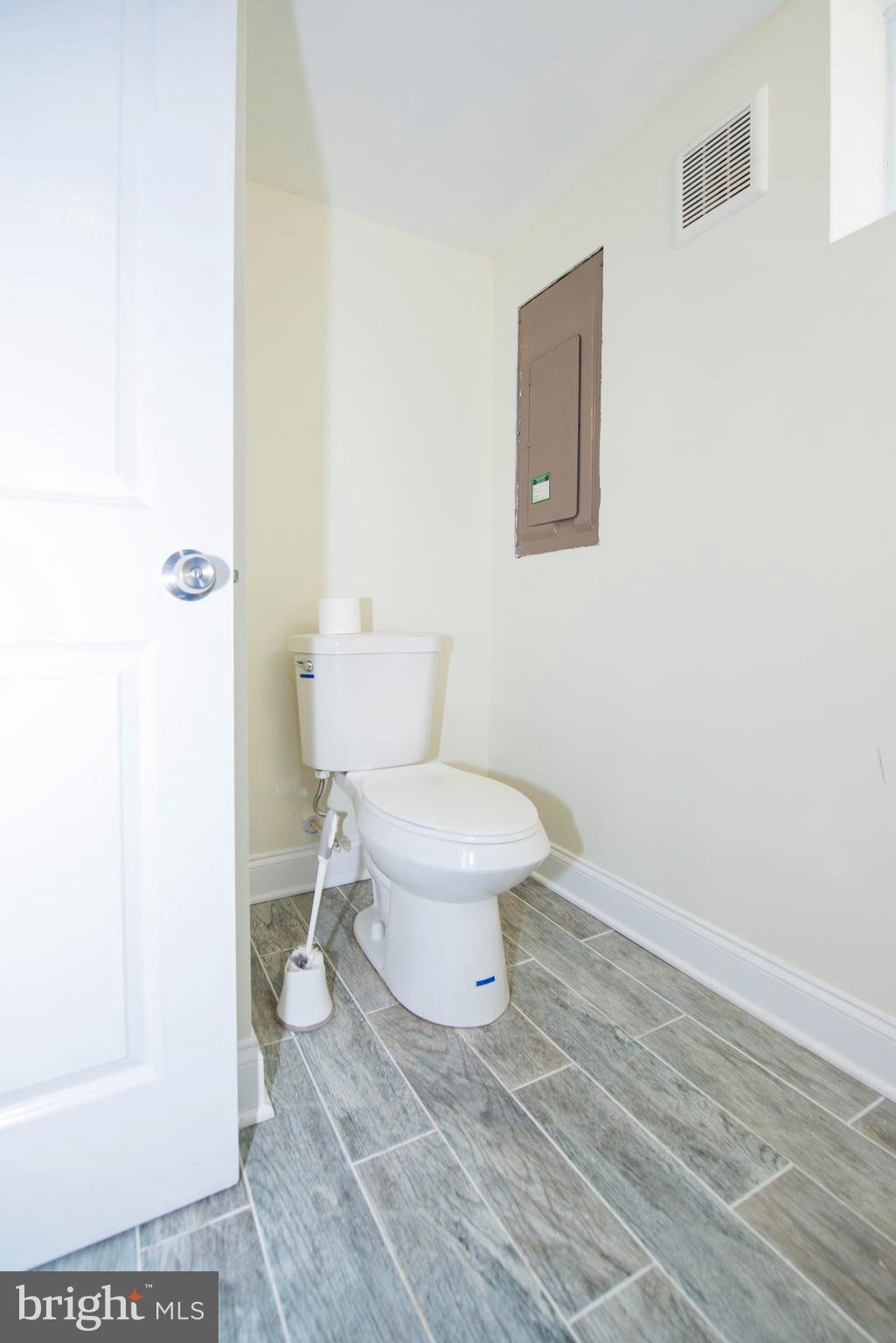 10909 Philadelphia Road White Marsh, MD 21162 - Photo 29 of 49 a white toilet sitting next to a white sink and vanity