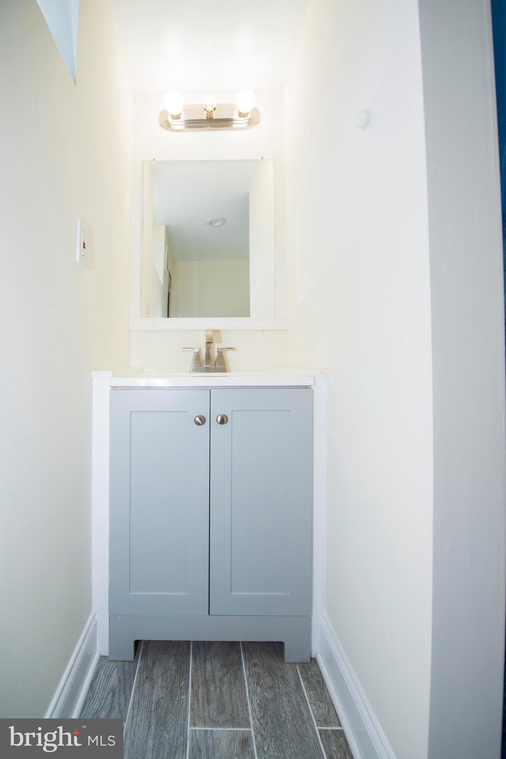 10909 Philadelphia Road White Marsh, MD 21162 - Photo 30 of 49 a bathroom with a sink and a mirror
