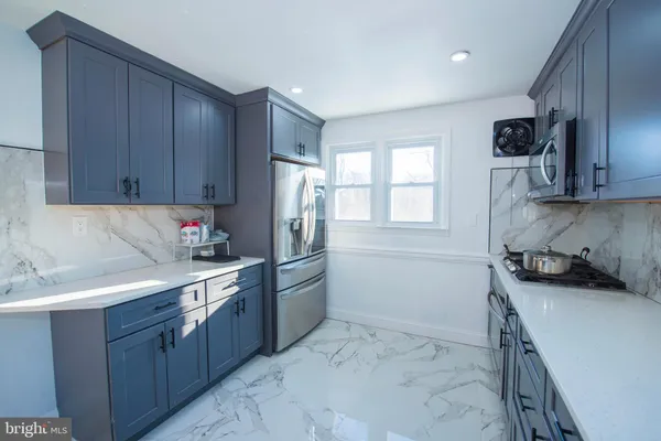 a kitchen with a sink stove and refrigerator