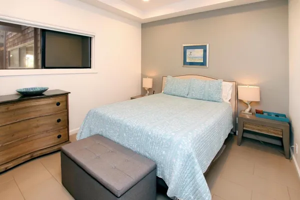 a bedroom with a bed and a television